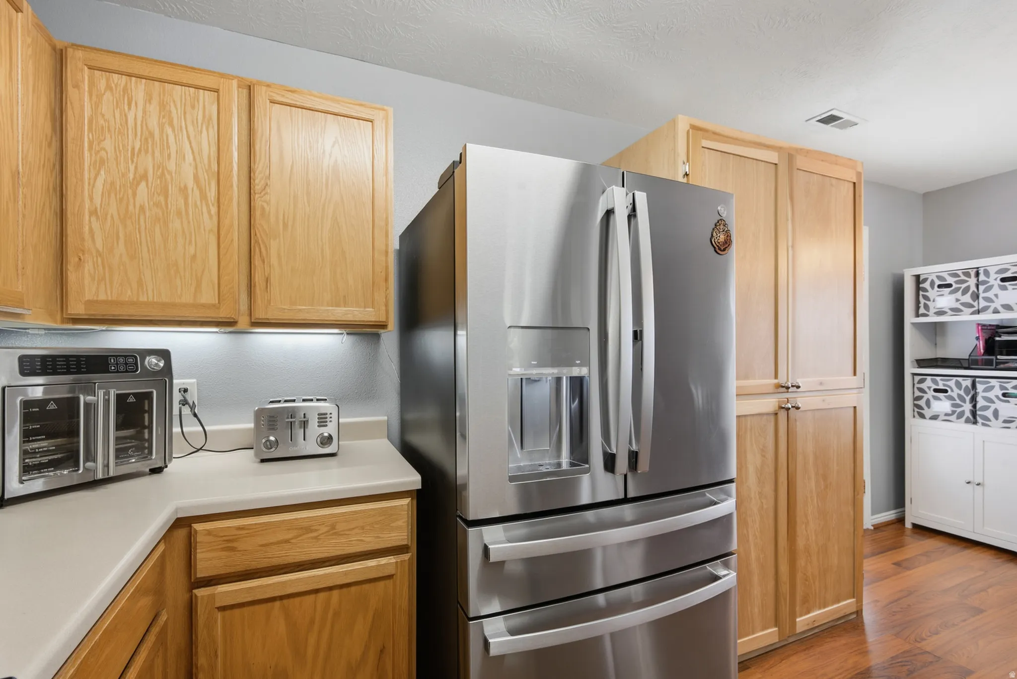 Wood-finish cabinetry paired with light-toned countertops