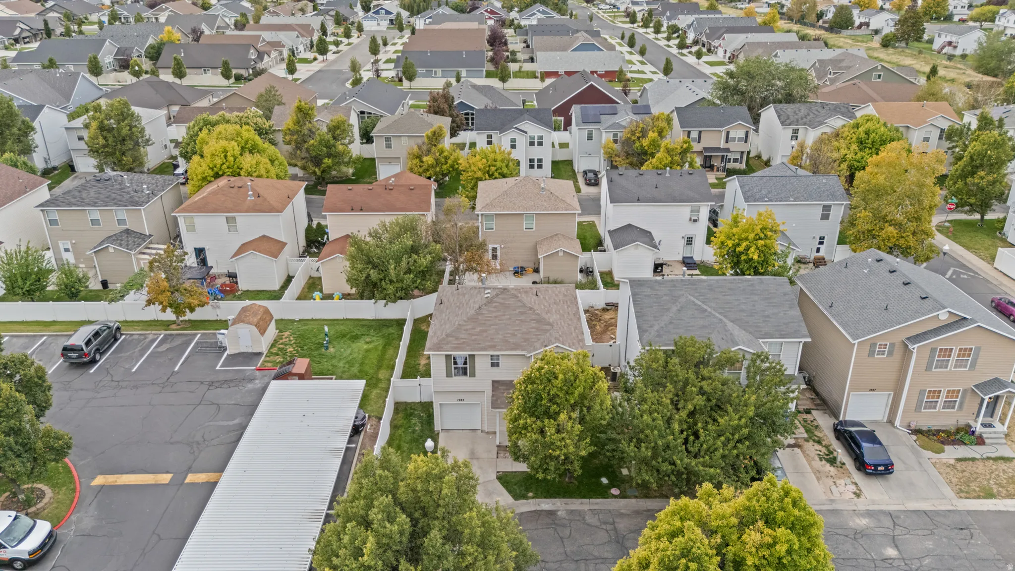 Residential neighborhood featuring single-family homes with pitched roofs and mature trees