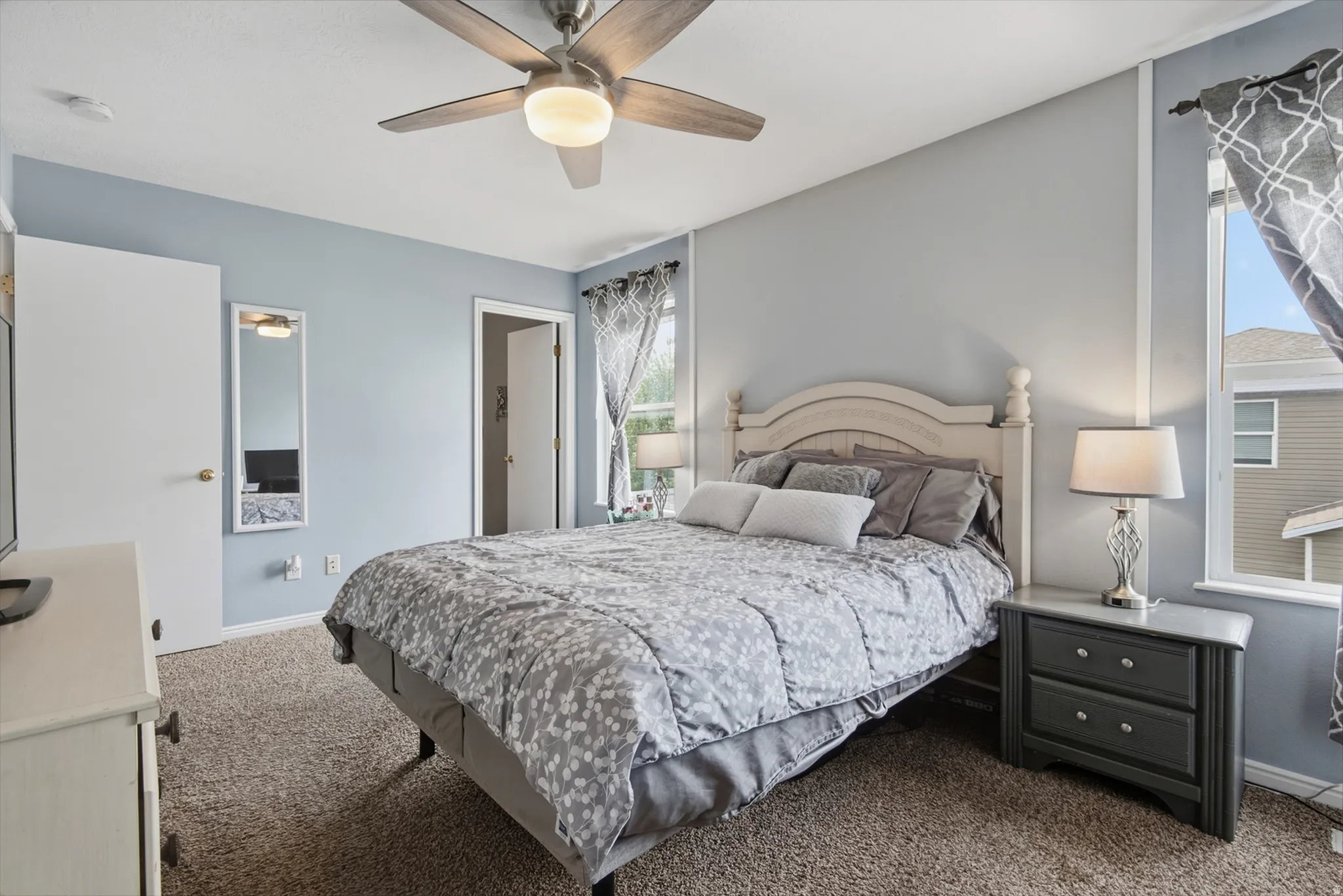 Recessed lighting with a ceiling fan, light-toned carpeting, and multiple windows