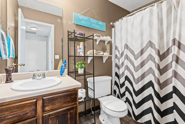 Built-in wood-finish vanity with an integrated sink and light-colored countertop