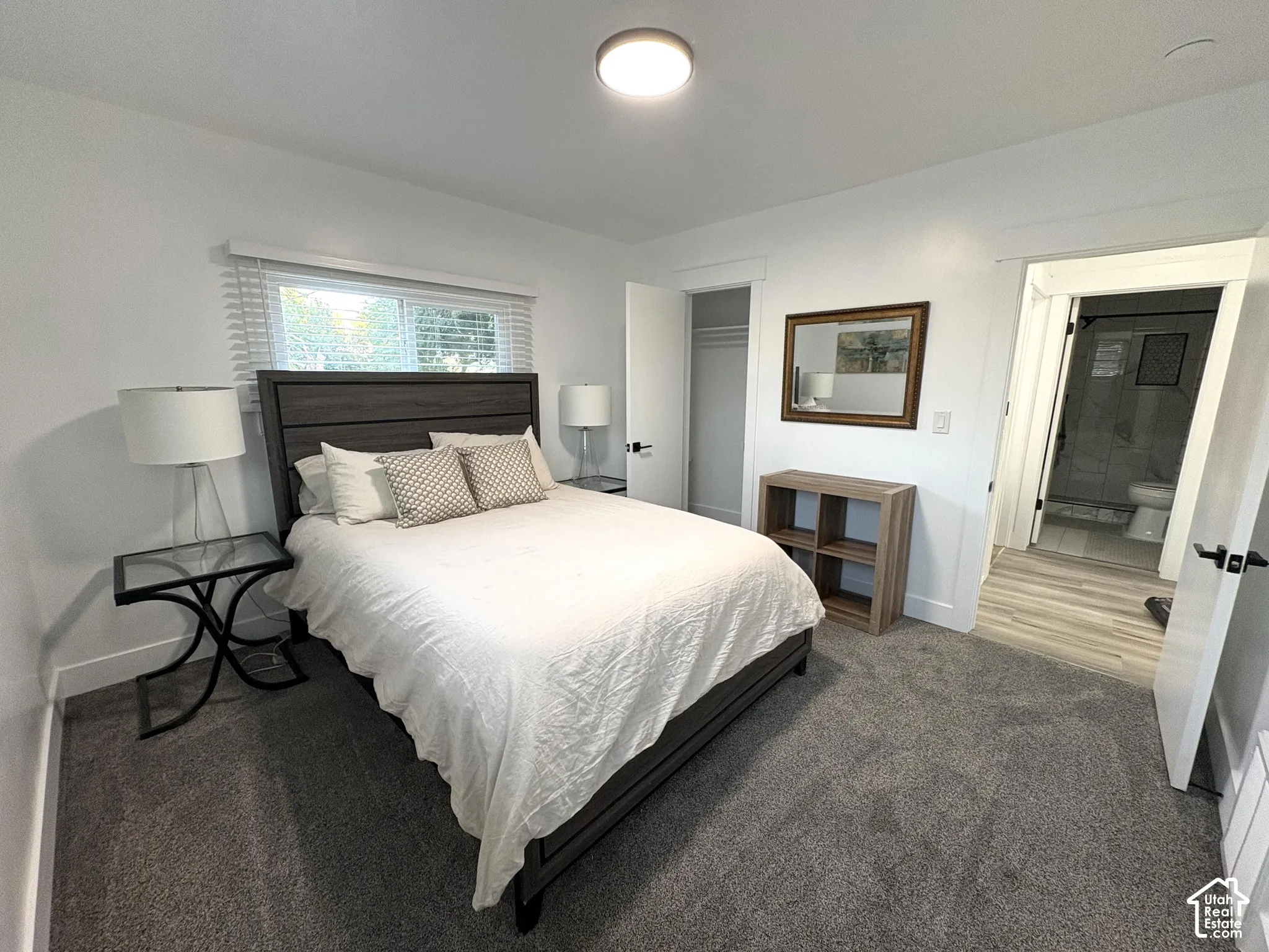 Wall-to-wall carpeting, recessed ceiling lighting, and a window with horizontal blinds