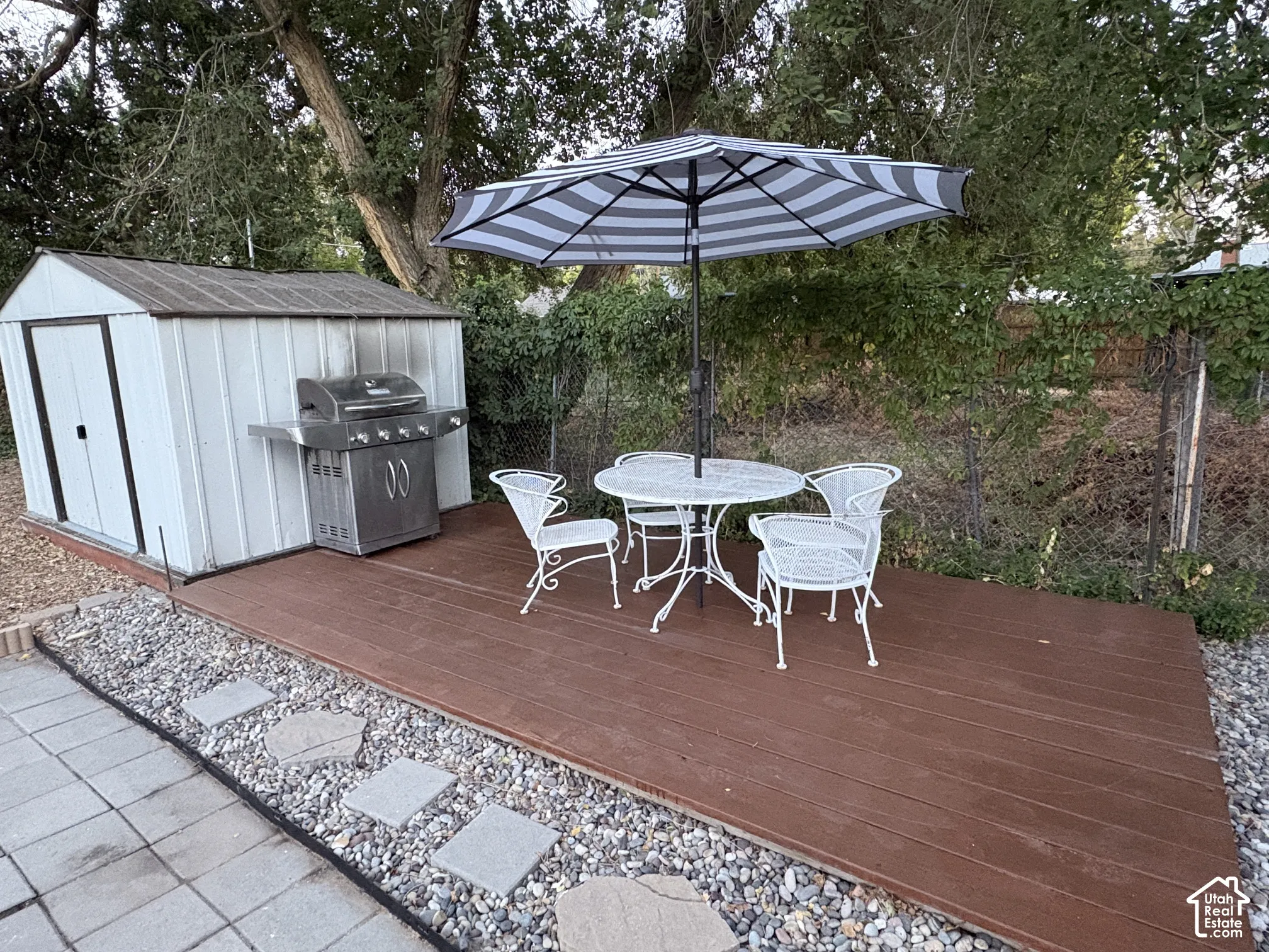 Exterior wood-finish decking with an adjacent storage shed