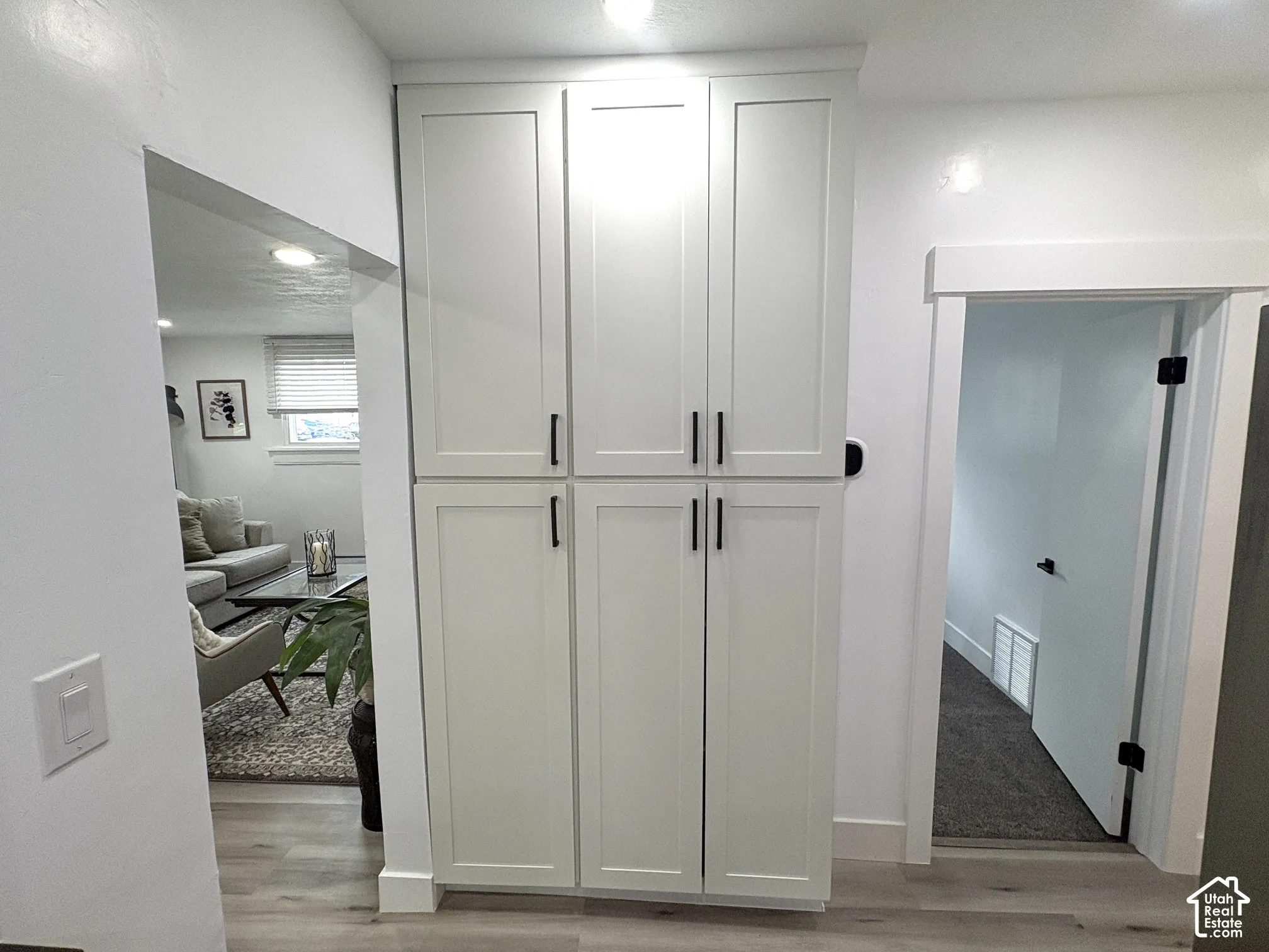 Built-in white shaker cabinetry with matte black hardware