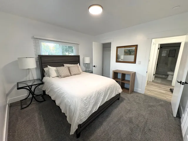 Wall-to-wall carpeting, recessed ceiling lighting, and a window with horizontal blinds