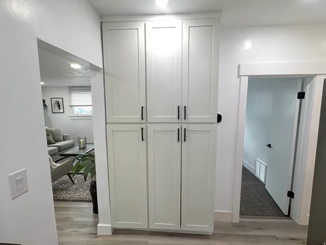 Built-in white shaker cabinetry with matte black hardware