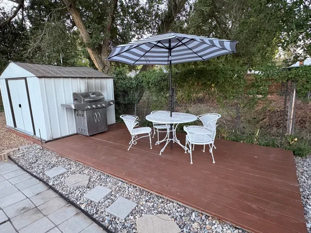 Exterior wood-finish decking with an adjacent storage shed