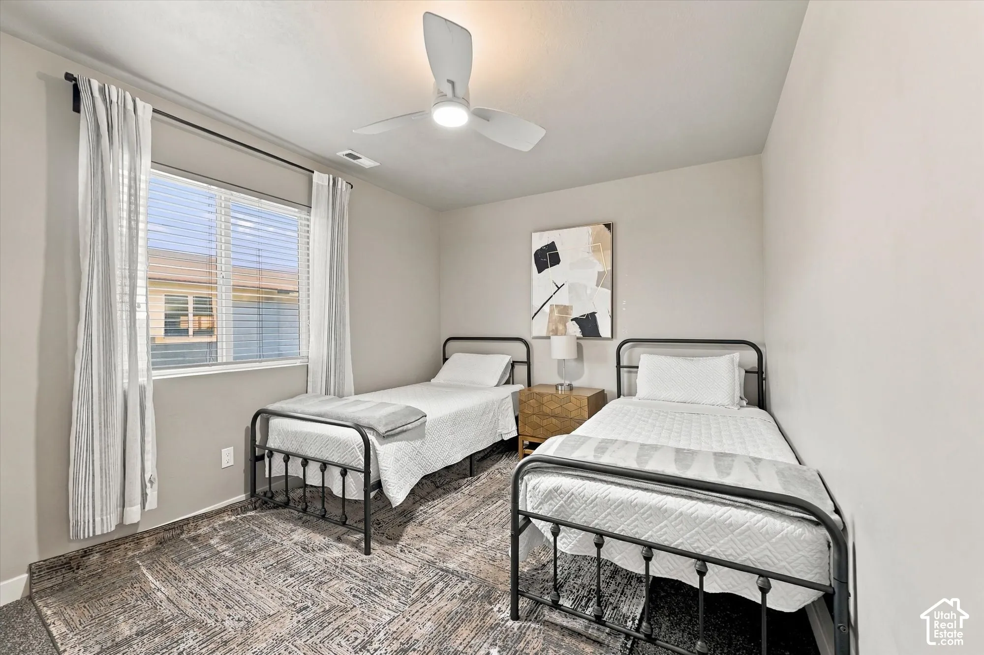 Neutral wall color, window with horizontal blinds, and a ceiling fan with integrated lighting