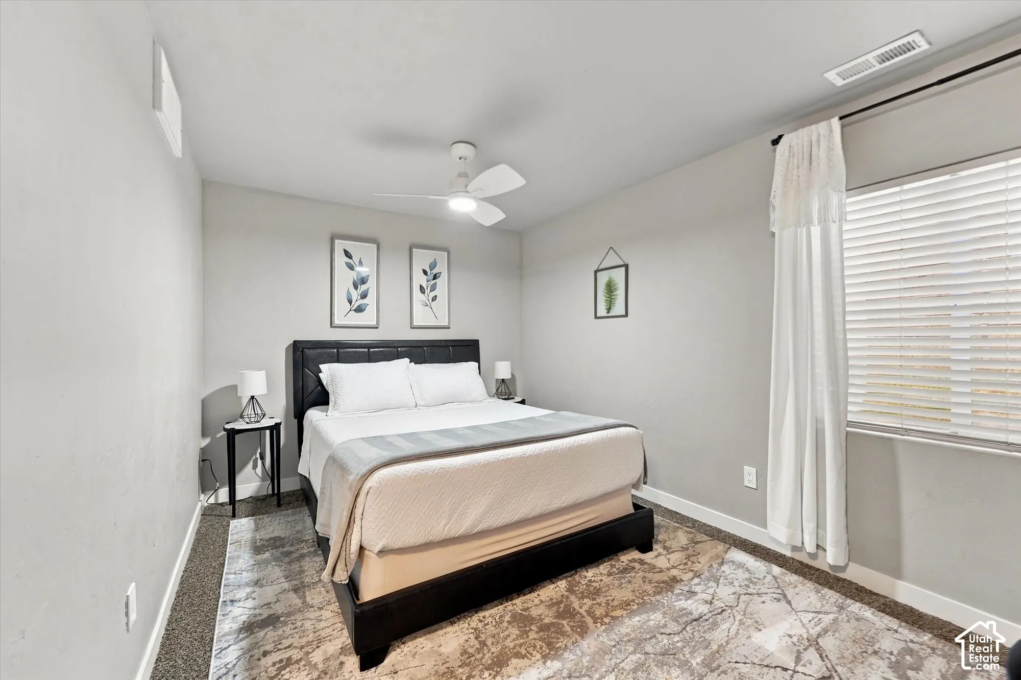 Ceiling fan with light fixture, window with blinds, and light gray wall paint