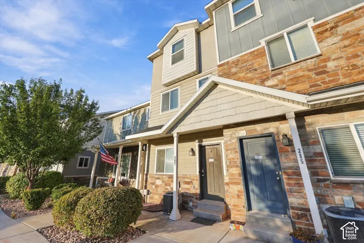 Multi-level exterior featuring stone and siding finishes