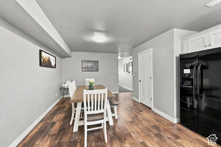 Wood-finish flooring, recessed lighting, and white cabinetry