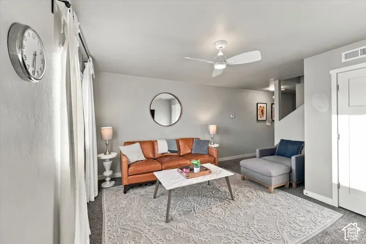 Recessed lighting, ceiling fan, and light gray walls complement the carpeted flooring