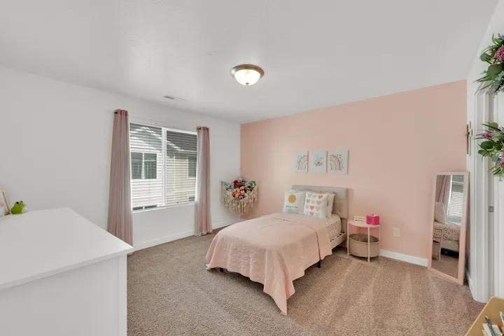 Carpeted flooring, window with blinds, flush mount ceiling light, and painted walls