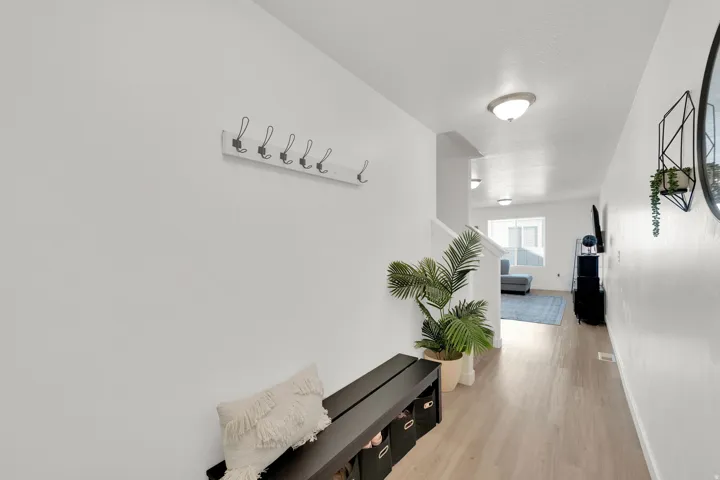 Neutral wall color, wood-finish flooring, and recessed lighting