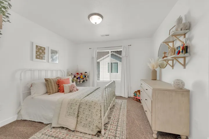 White walls, recessed lighting, and a window with blinds