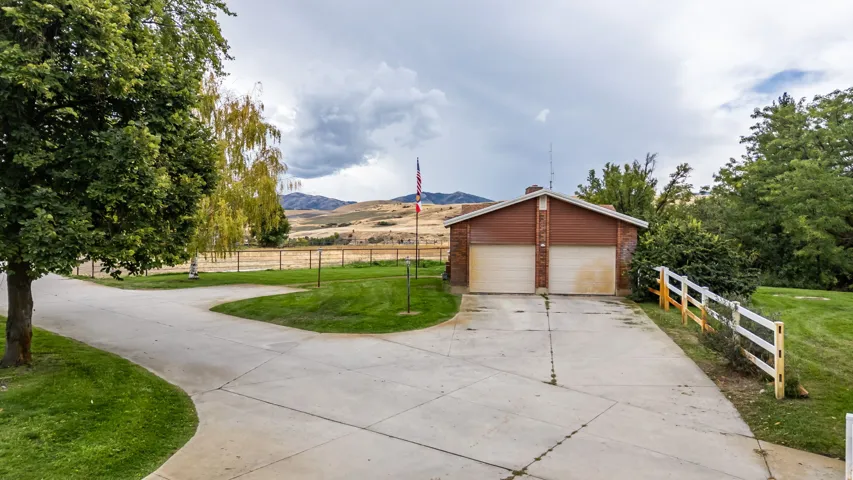 Concrete driveway leading to a two-car garage with overhead doors