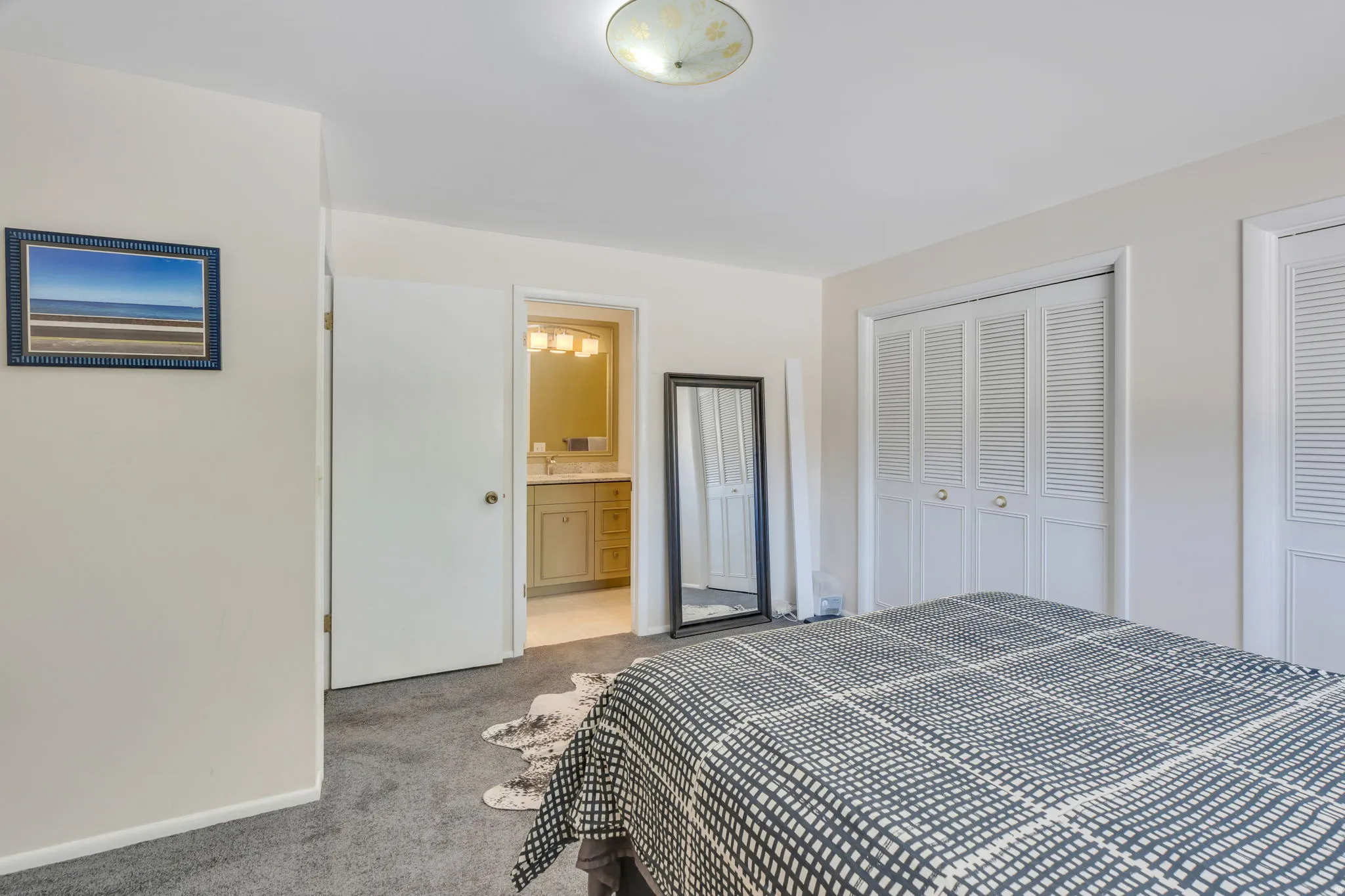 Plush carpet flooring, white bi-fold closet doors, and recessed lighting