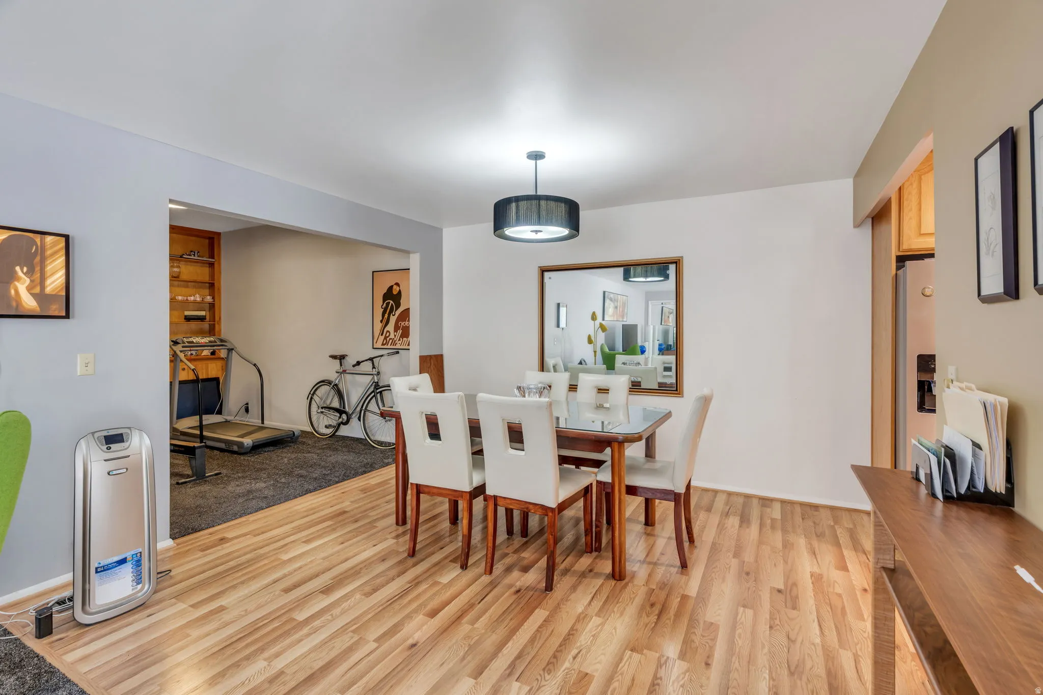 Wood-finish flooring, recessed lighting, and a contemporary drum pendant light