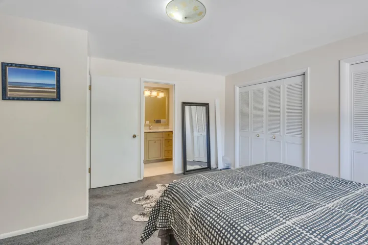 Plush carpet flooring, white bi-fold closet doors, and recessed lighting