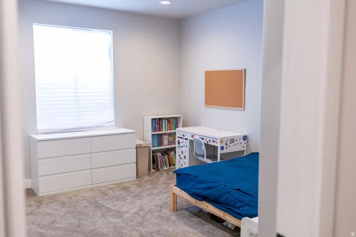 Recessed lighting, wall-to-wall carpeting, and a window with blinds