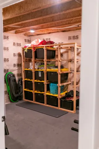 Unfinished space featuring exposed ceiling joists, insulated walls, and concrete flooring