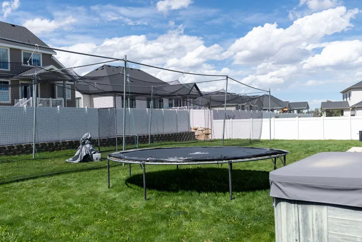 Manicured lawn, full privacy fencing, and an integrated hot tub feature