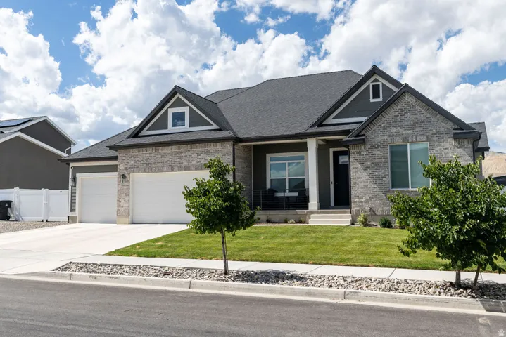 Stone and siding exterior with a dark shingle roof