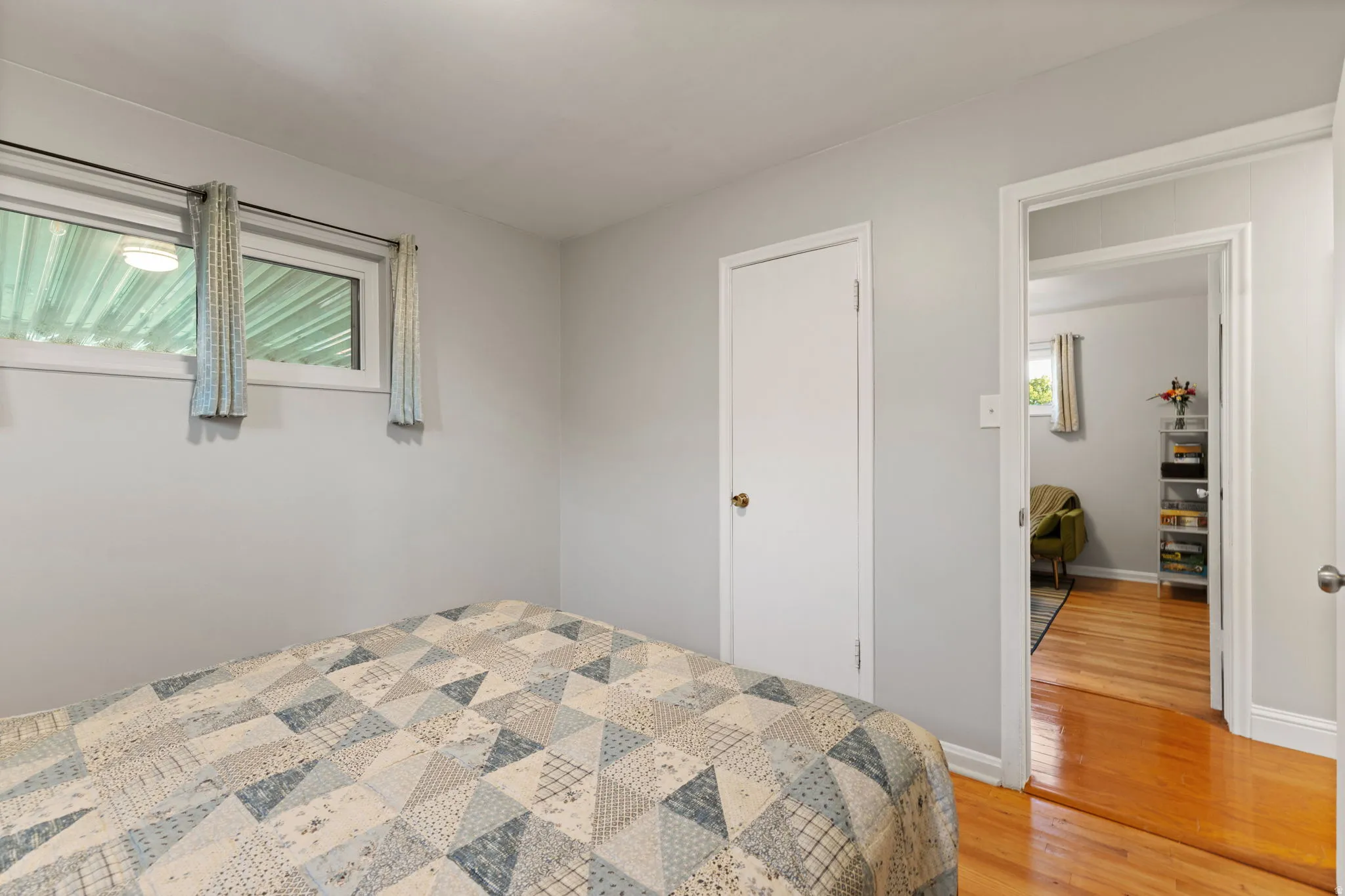 Hardwood-style flooring extends through the doorway, complemented by light gray wall finishes and white trim