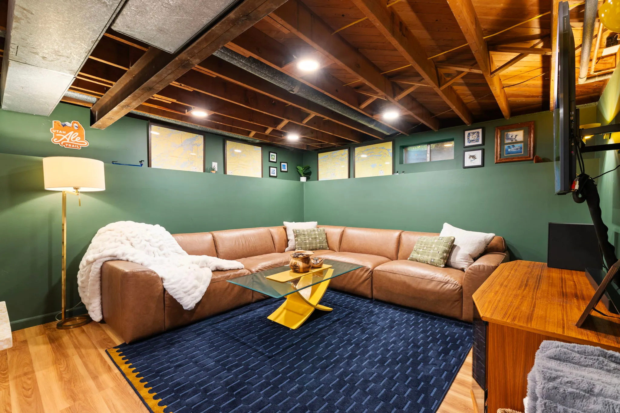 Exposed wood beam ceiling, recessed lighting, wood-finish flooring, and green wall accents