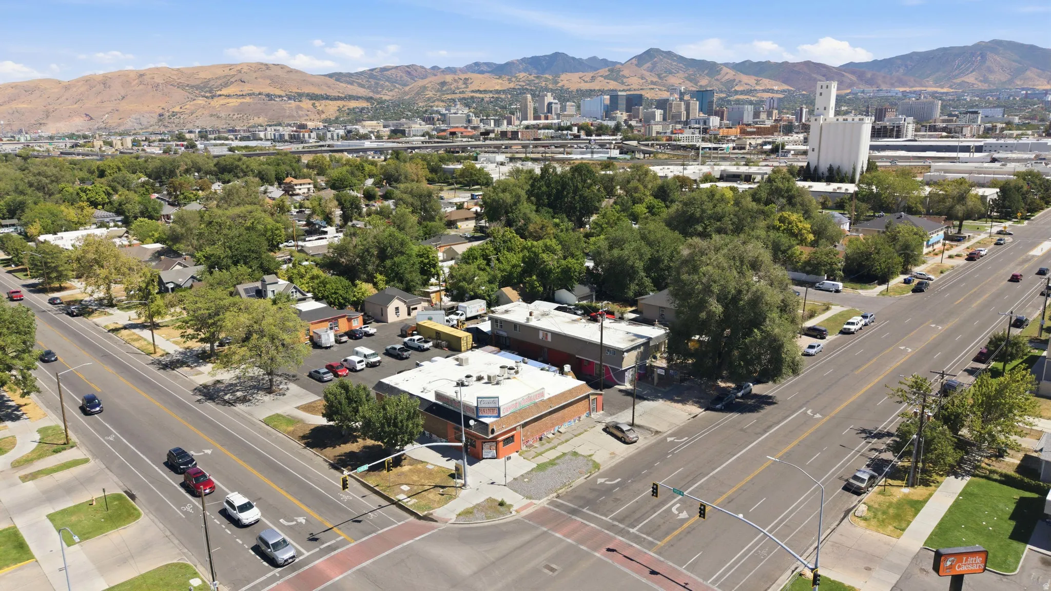 Corner lot property featuring two commercial buildings, paved parking, and direct street access