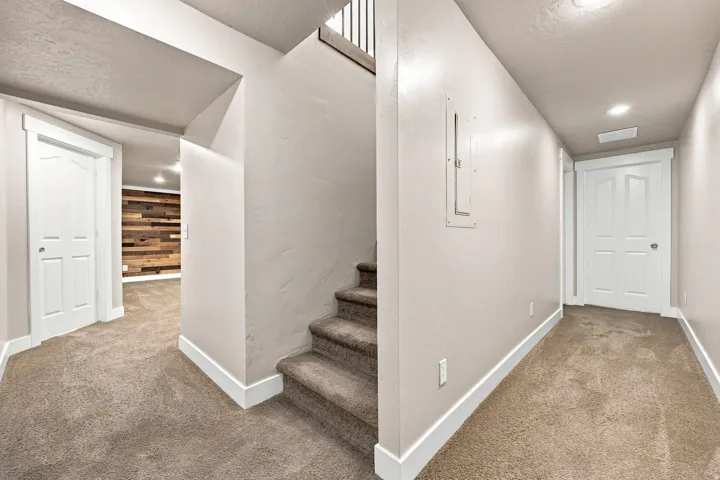 Carpeted flooring, white trim, recessed lighting, and white paneled doors
