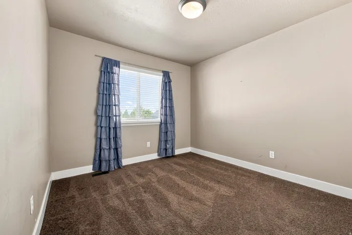bed 2. Recessed window with blinds, overhead flush mount lighting, and carpeted flooring