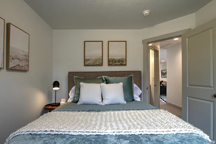 Recessed lighting illuminates the doorway with trim detailing