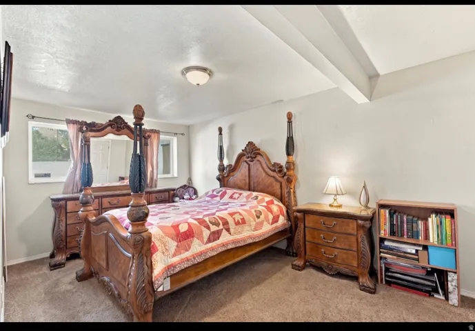 Carpeted flooring, recessed ceiling lighting, and multiple windows