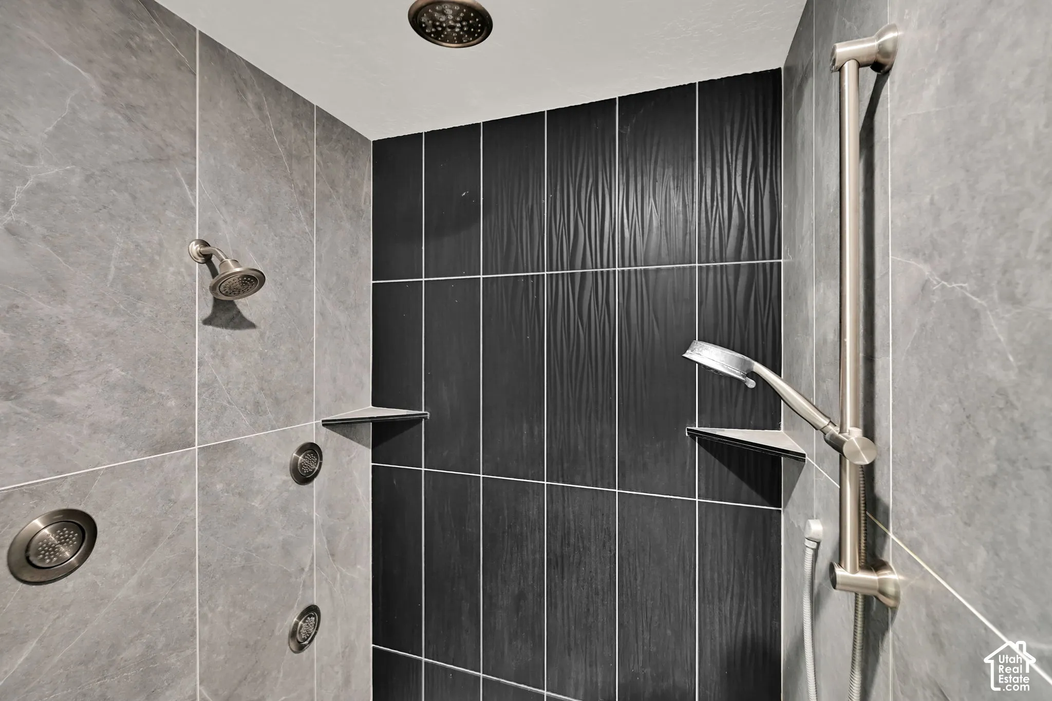 Master bath shower featuring a ceiling-mounted rain showerhead, wall-mounted showerhead, and body spray jets