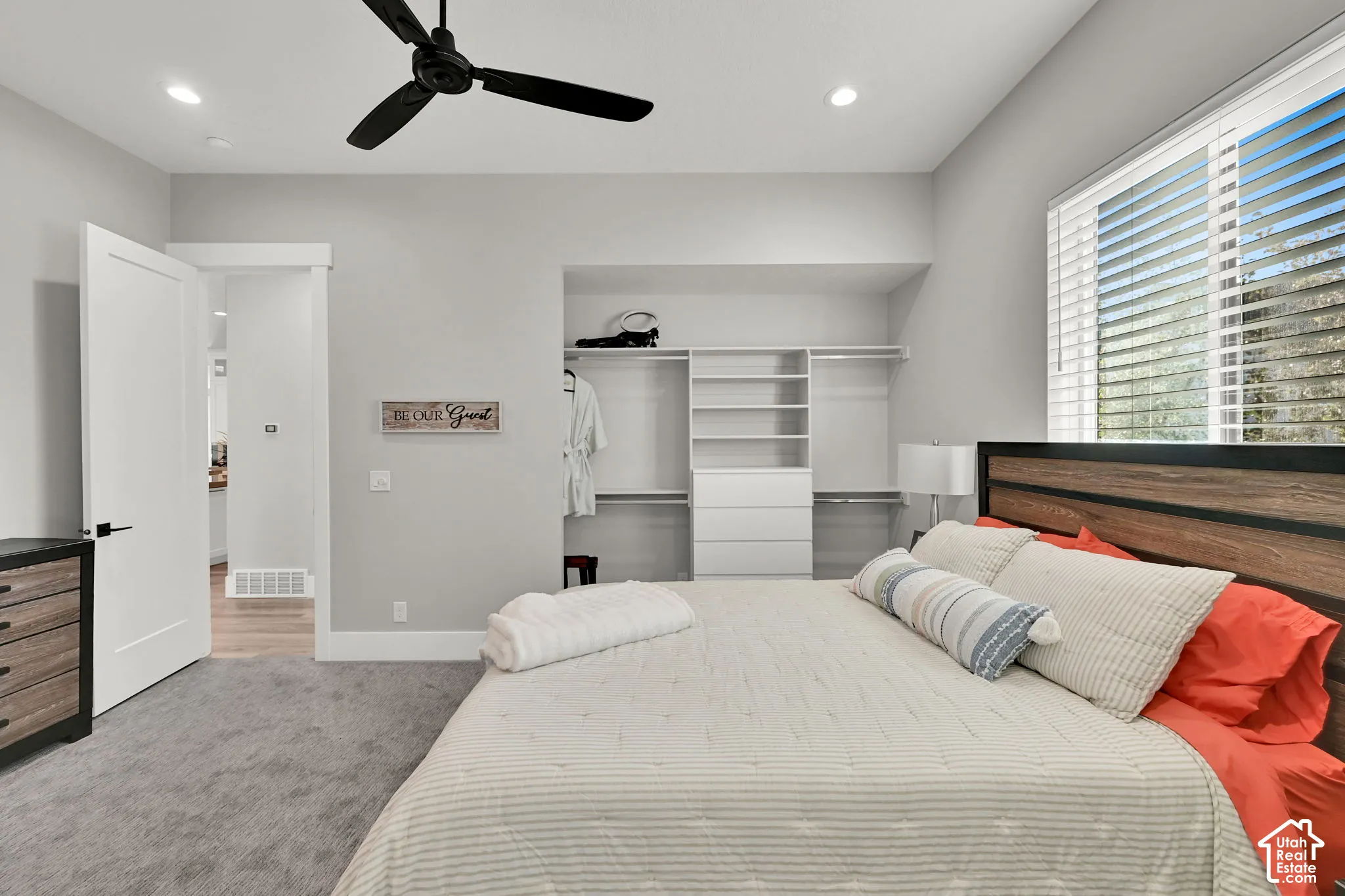 Recessed lighting, ceiling fan, built-in closet organization system, large window with blinds.