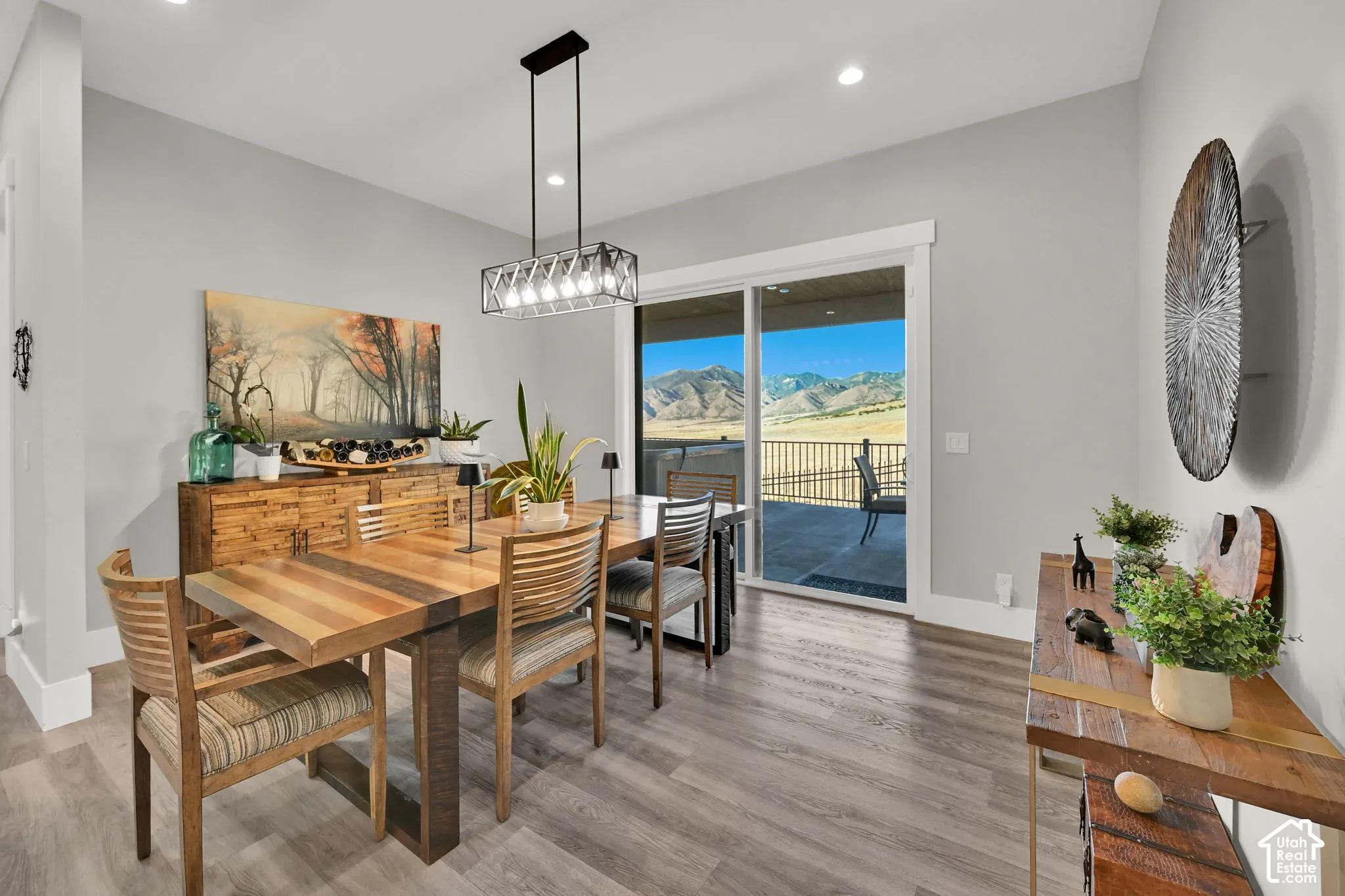 Sliding glass doors to outdoor patio, recessed lighting, wood-finish flooring, and a modern rectangular chandelier