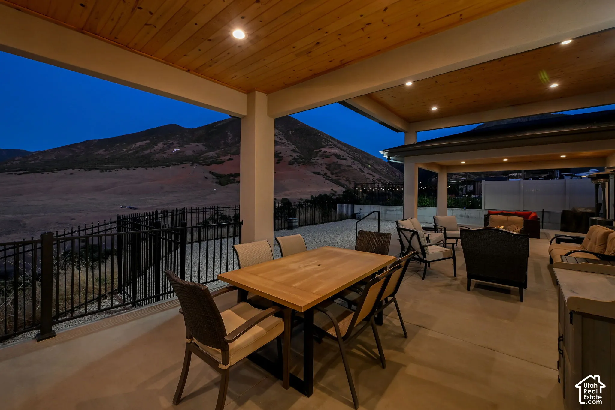 Covered patio with a wood-panel ceiling and recessed lighting