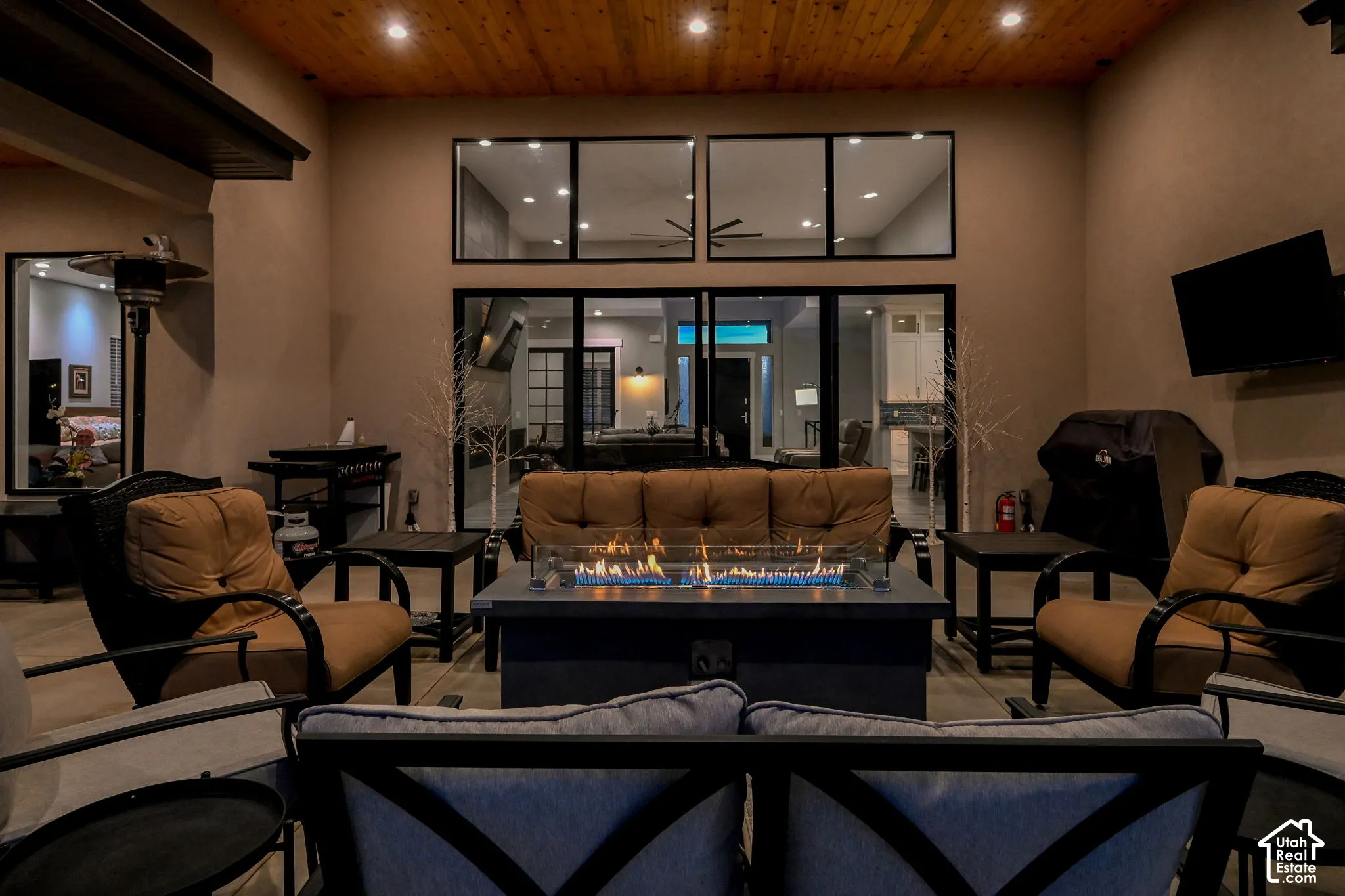 Covered outdoor patio with a wood-finish ceiling, and recessed lighting.