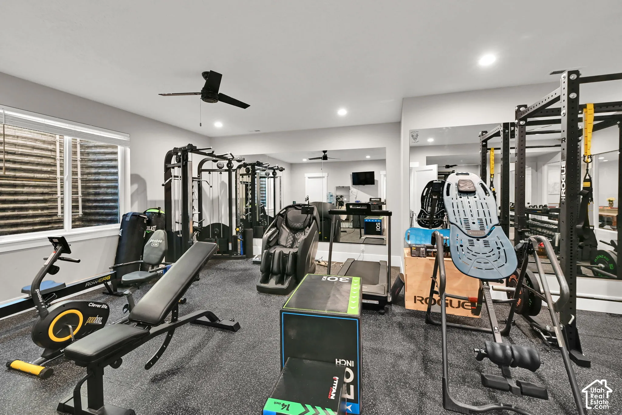 Spacious recreation room featuring recessed lighting, a ceiling fan, and a large window. This is the 6th bedroom used as a gym.