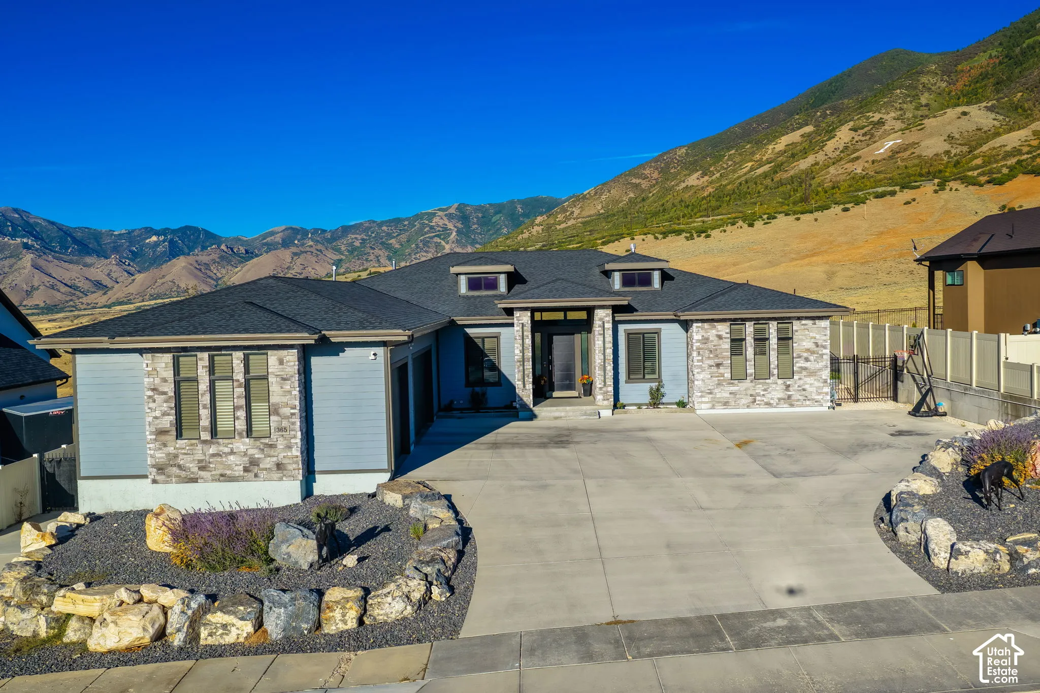 Modern exterior with light blue siding and stone accents