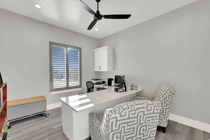 Recessed lighting, ceiling fan, wood-finish flooring, plantation shutters, and built-in cabinetry