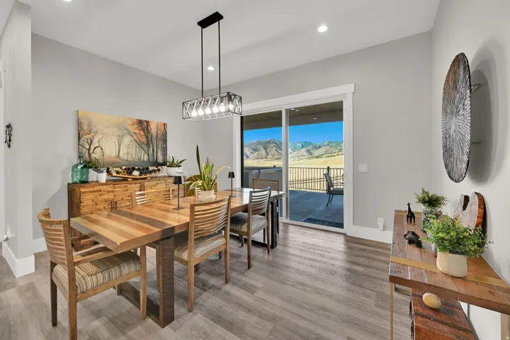 Sliding glass doors to outdoor patio, recessed lighting, wood-finish flooring, and a modern rectangular chandelier