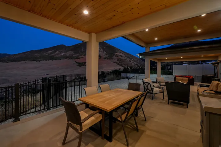 Covered patio with a wood-panel ceiling and recessed lighting