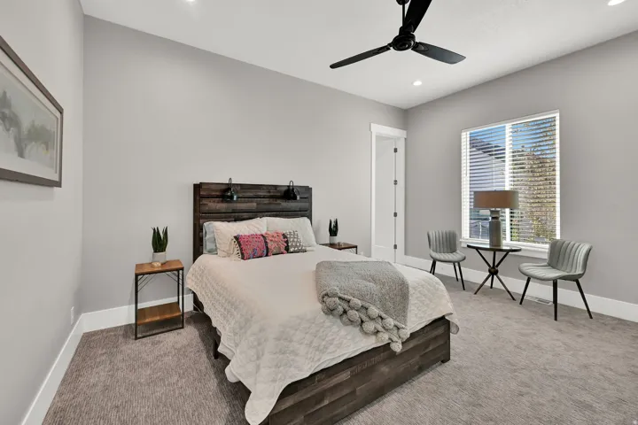 Recessed lighting, ceiling fan, window with horizontal blinds, light gray wall color, and gray carpeting
