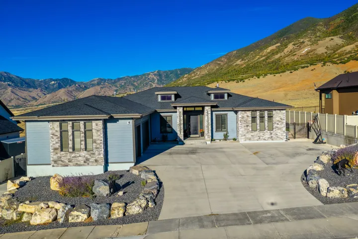 Modern exterior with light blue siding and stone accents