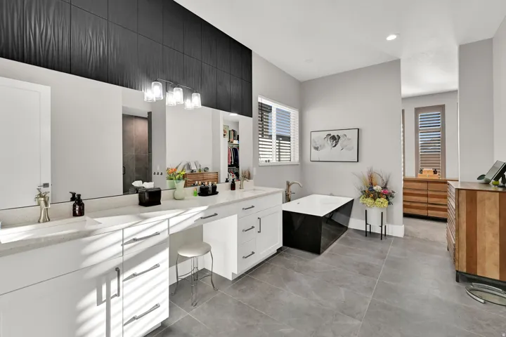 Master Bath Dual vanity with integrated sinks, white cabinetry, and quartz countertops