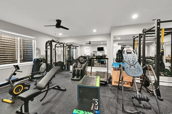 Spacious recreation room featuring recessed lighting, a ceiling fan, and a large window