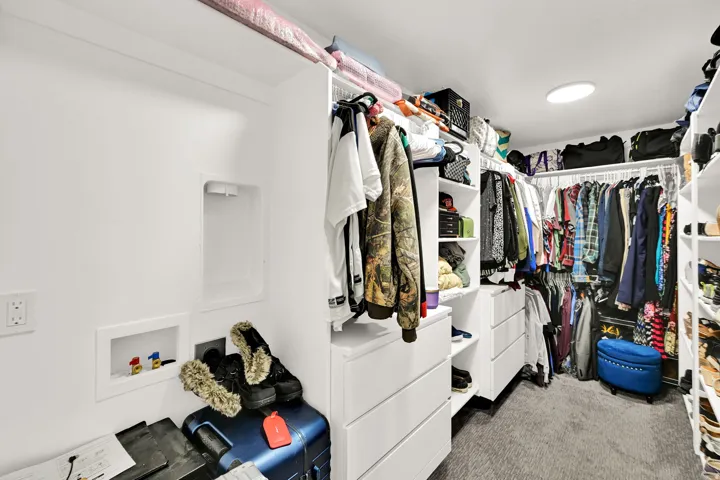 Built-in shelving and drawers, clothing rods, and wall-mounted laundry hookups. Laundry hookups in closet.