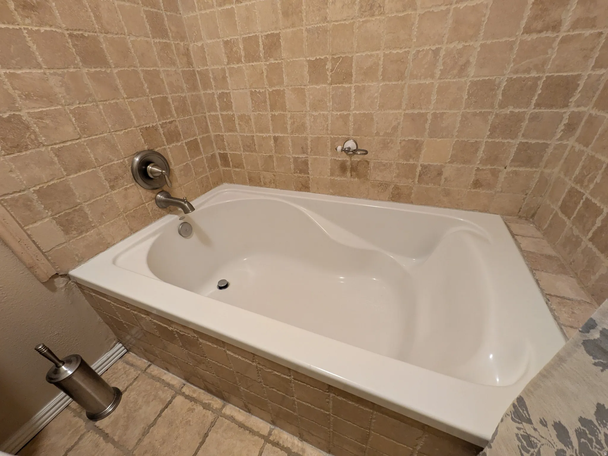 Soaking tub with tile surround and brushed nickel fixtures