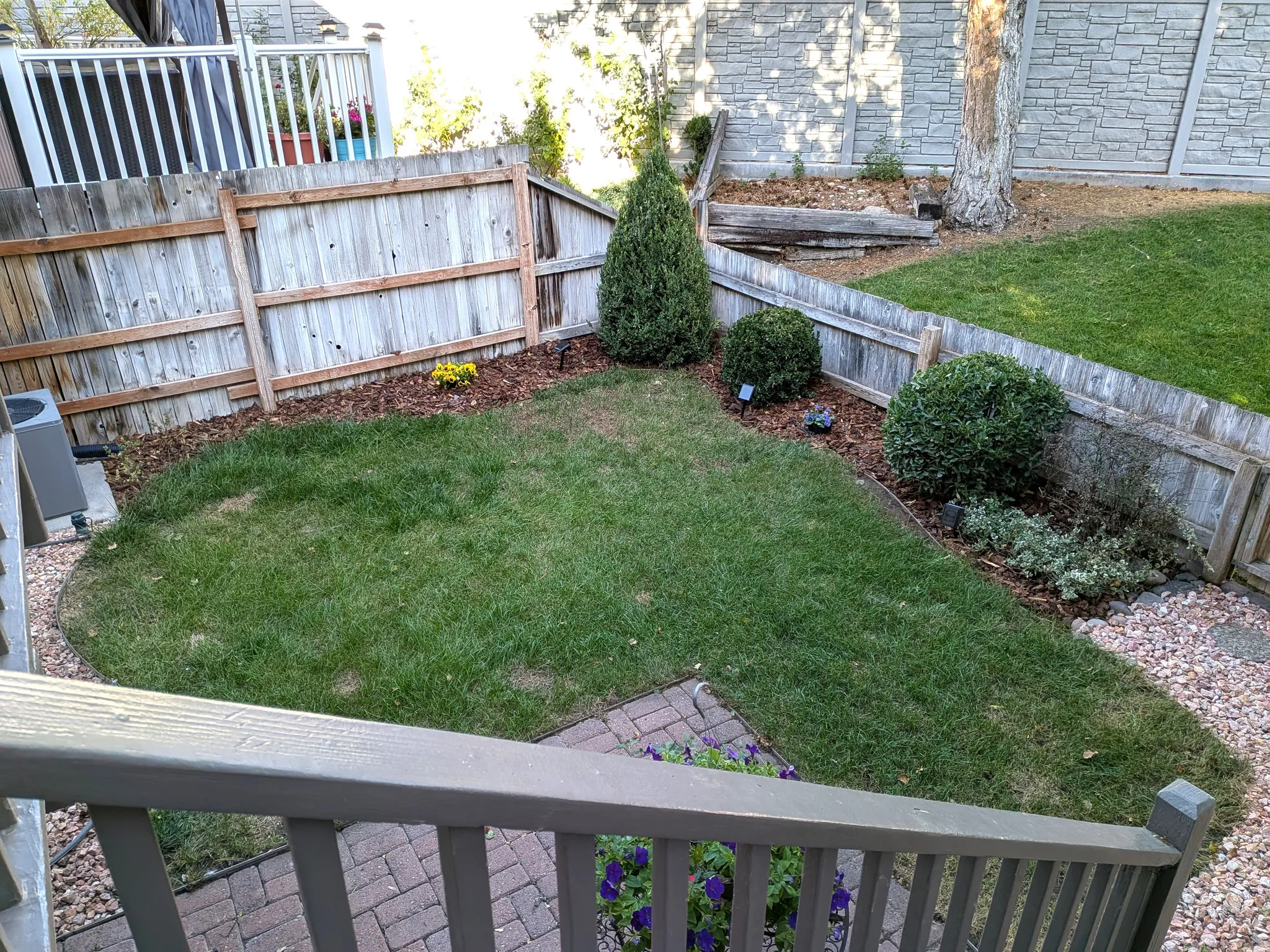 Manicured lawn area with wood chip landscaping